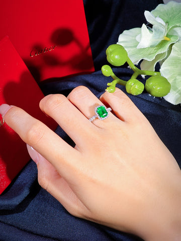 Cartier Destinée emerald solitaire ring shown on hand