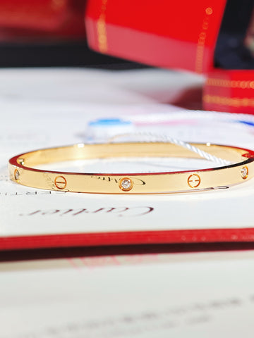 Cartier LOVE small-model 18K rose gold bracelet with six diamonds, close-up