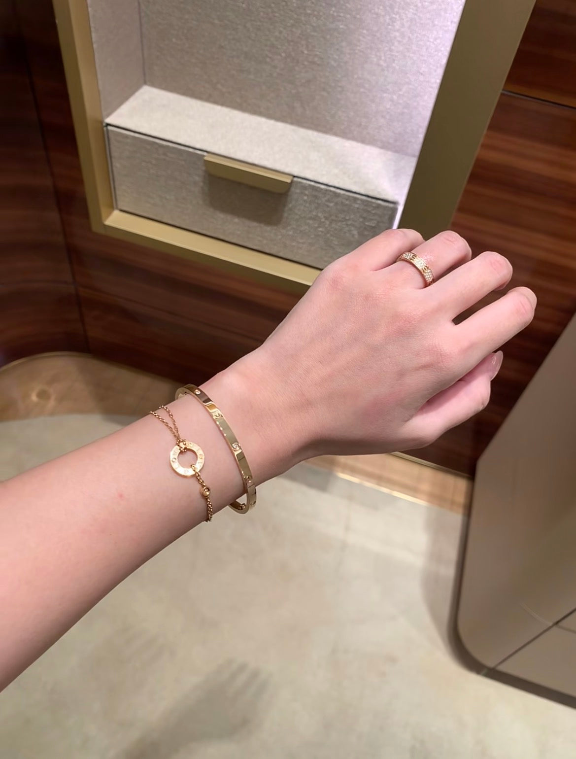 Lifestyle view of the Cartier LOVE Bracelet, Small Model, Six Diamonds worn on the wrist; other jewelry shown is not included.