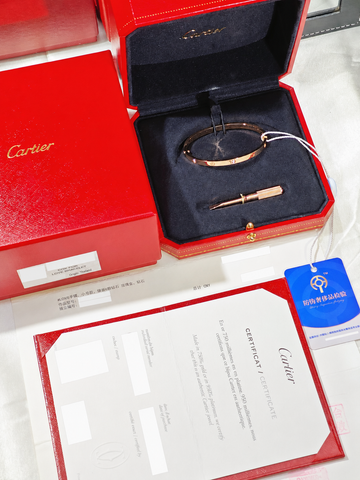 Redacted Cartier certificate and sales invoice displayed with the LOVE bracelet and screwdriver