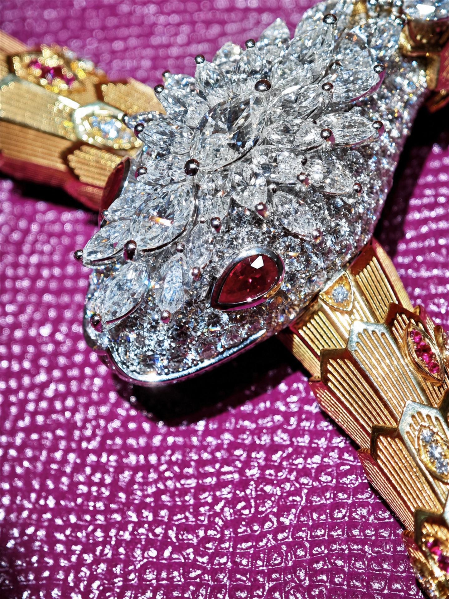 BVLGARI Serpenti high jewelry ruby and diamond lariat necklace, diamond-pavé serpent head close-up