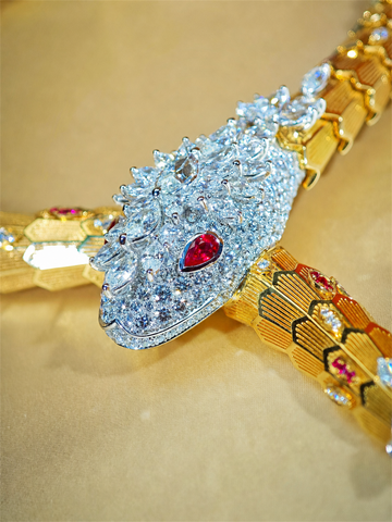 BVLGARI Serpenti high jewelry ruby and diamond lariat necklace, ruby-eyed serpent head detail
