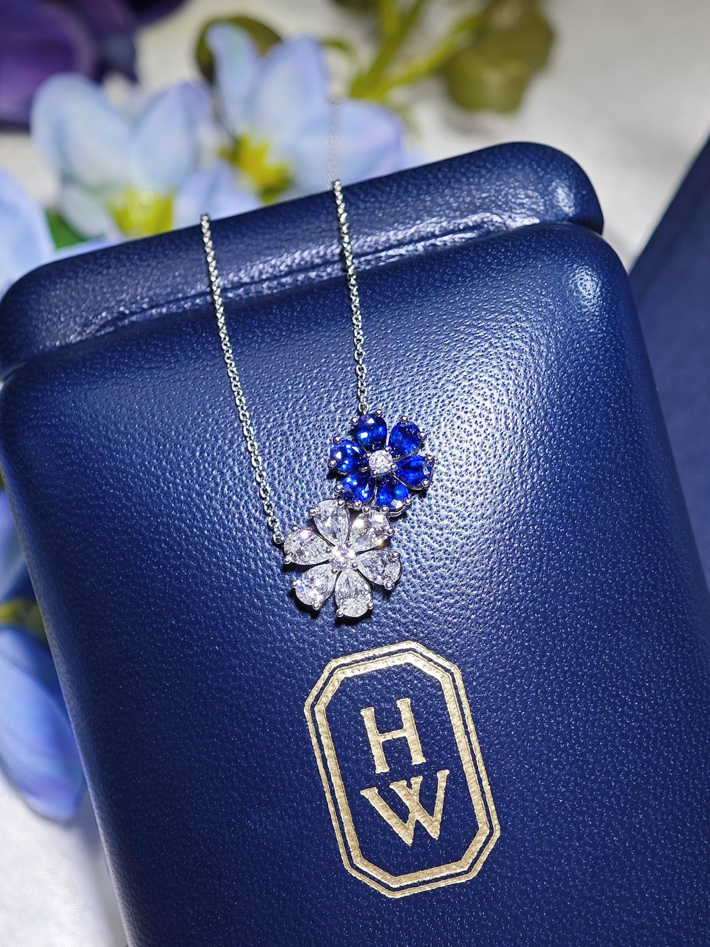 Harry Winston Forget-Me-Not twin pendant necklace on presentation case