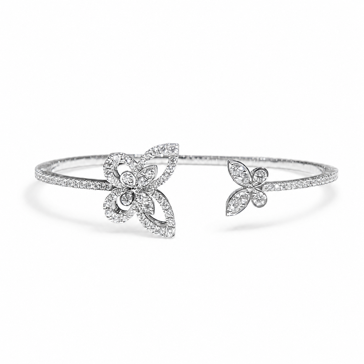 GRAFF Butterfly Silhouette open diamond bangle in 18K white gold on a neutral white background
