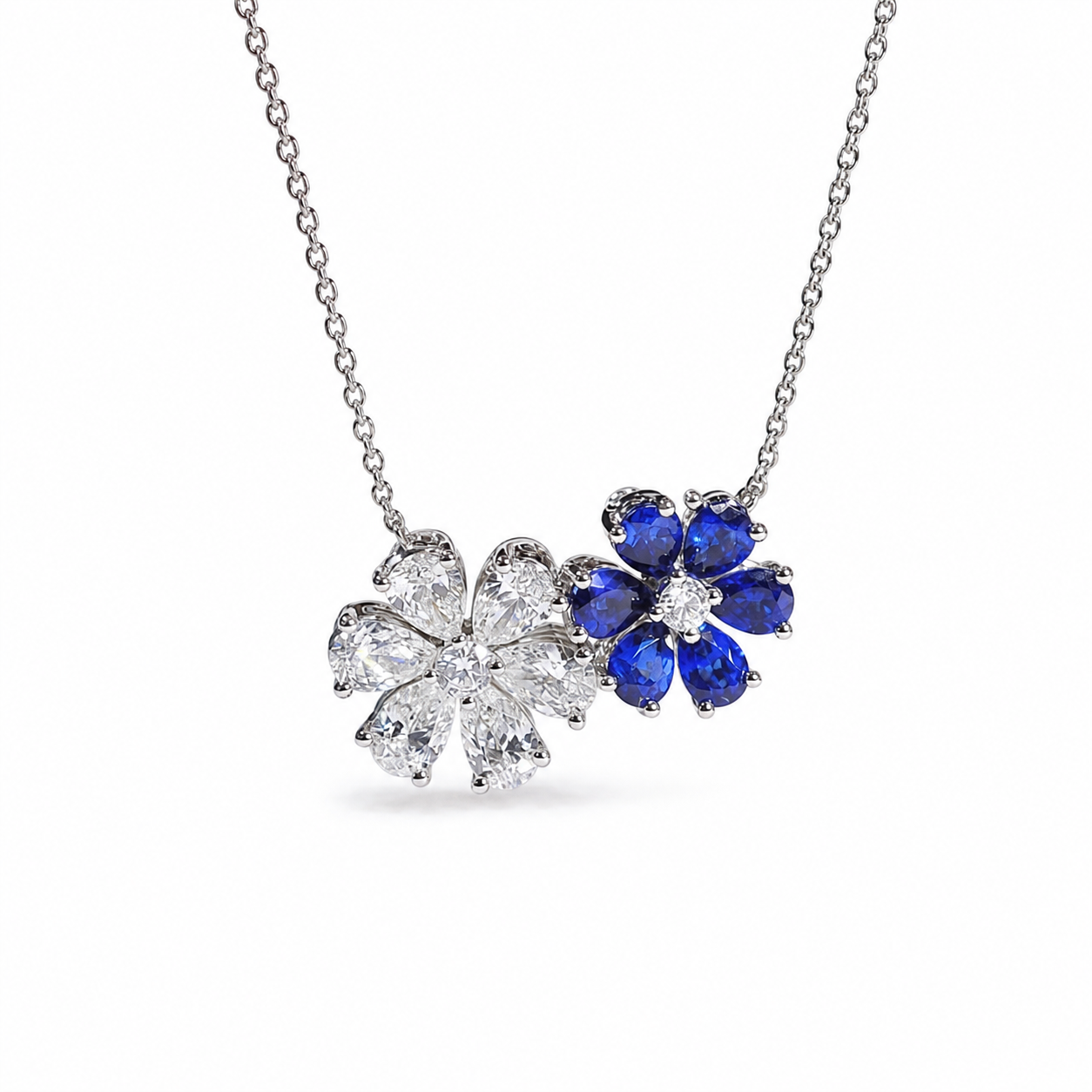 Harry Winston Forget-Me-Not sapphire and diamond twin pendant necklace in platinum on a white background